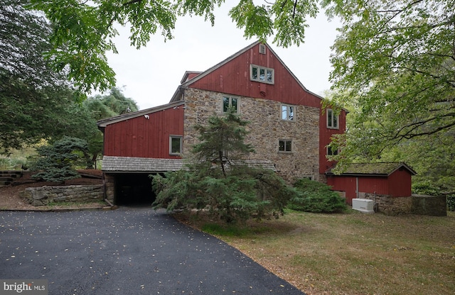 view of side of home with a yard