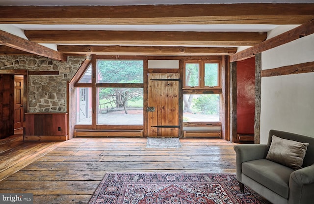 interior space with beamed ceiling and hardwood / wood-style floors