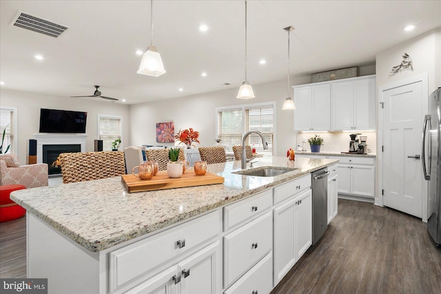 kitchen featuring an island with sink, white cabinetry, appliances with stainless steel finishes, and sink