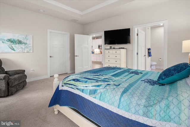 bedroom featuring connected bathroom and carpet flooring