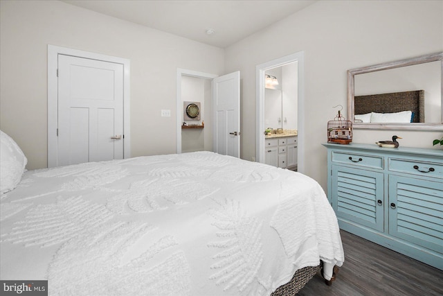 bedroom featuring a closet, ensuite bathroom, and dark hardwood / wood-style flooring