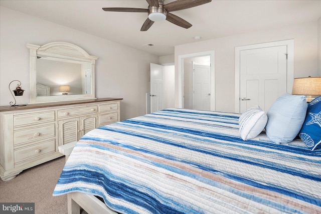 bedroom featuring light carpet and ceiling fan