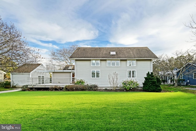 rear view of house featuring a lawn