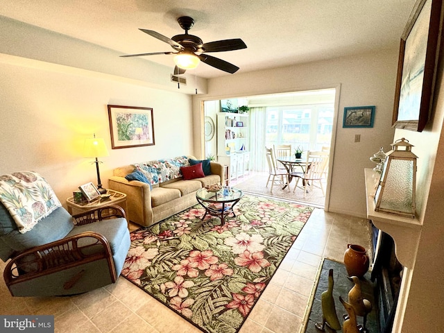 living room featuring ceiling fan and light tile patterned floors