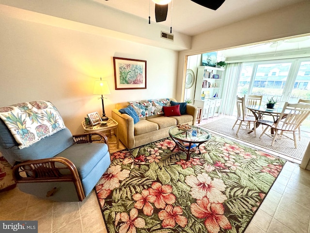 tiled living room with ceiling fan