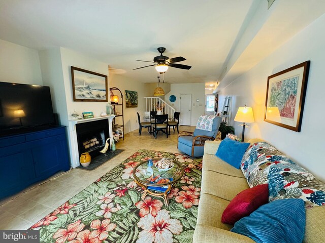 living room with ceiling fan and light tile patterned floors