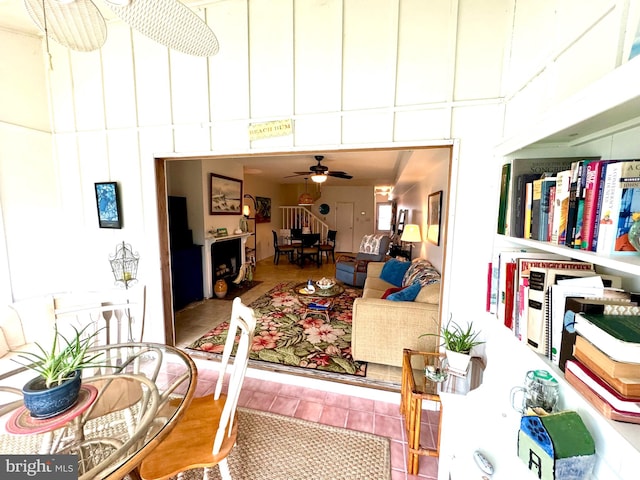 tiled living room featuring ceiling fan