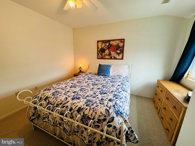 bedroom featuring ceiling fan, carpet floors, and vaulted ceiling