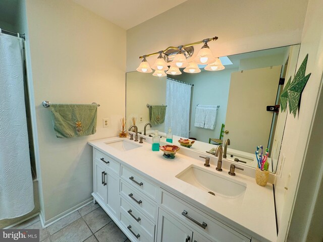 bathroom with tile patterned flooring, vanity, and shower / bath combo with shower curtain