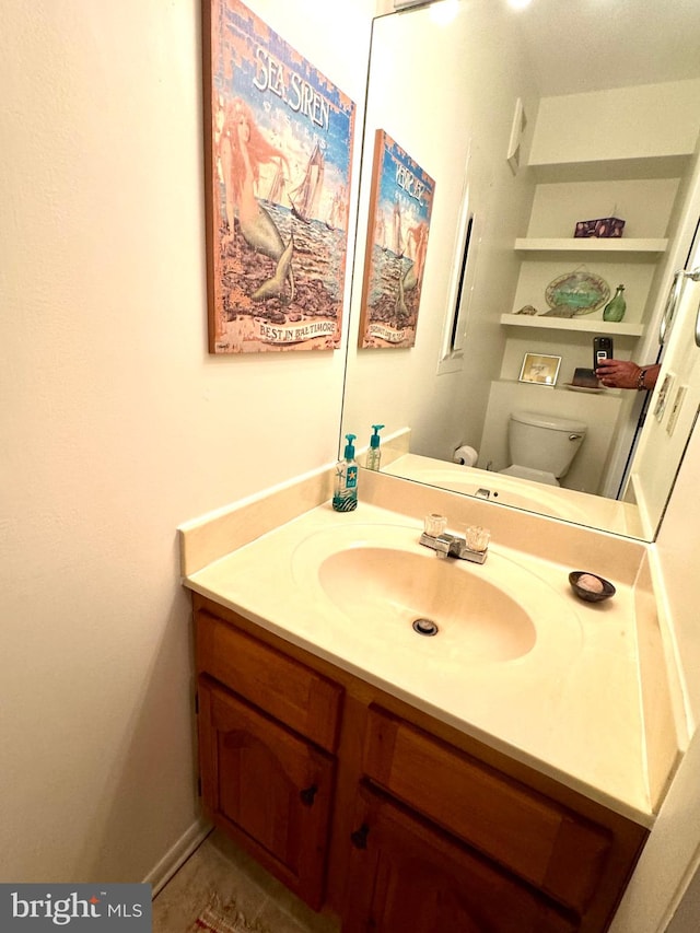 bathroom featuring vanity and toilet