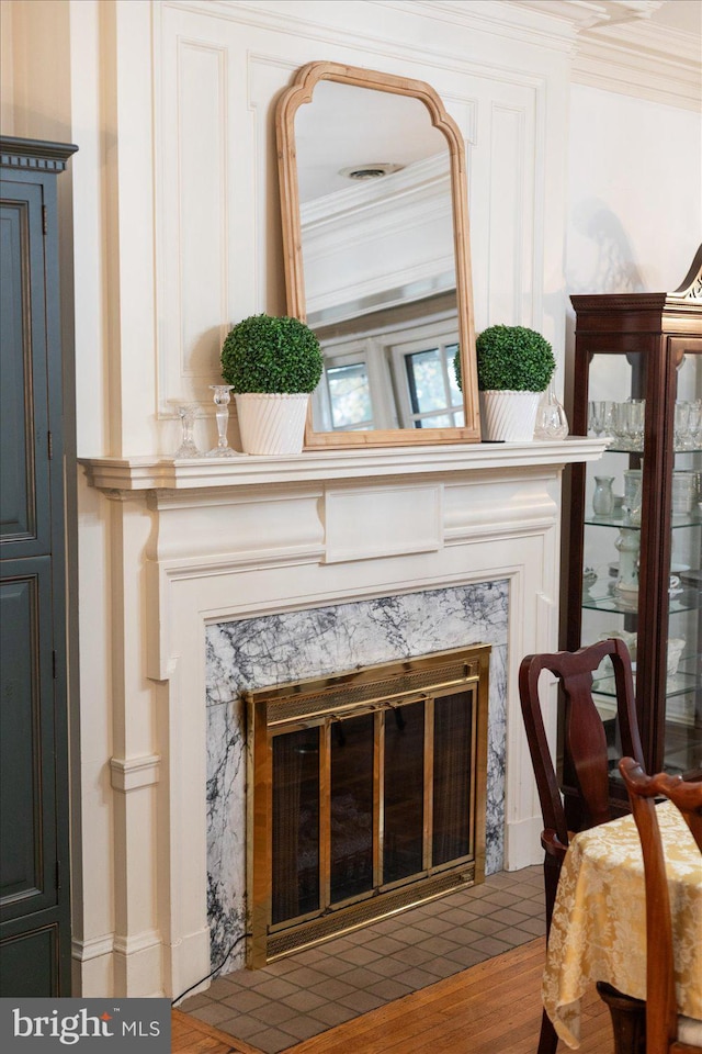 interior details featuring crown molding and a high end fireplace