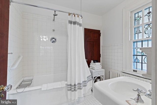 bathroom with tile patterned floors, tile walls, and shower / tub combo