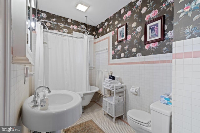 bathroom featuring radiator, a shower with curtain, sink, tile patterned flooring, and toilet