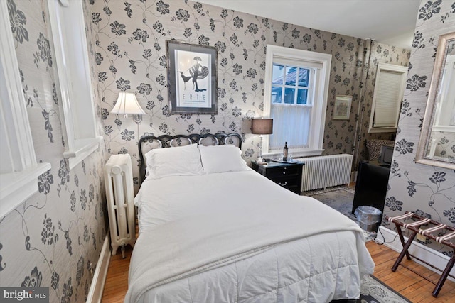 bedroom featuring wood-type flooring and radiator