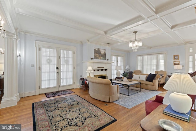 living room with coffered ceiling, light hardwood / wood-style floors, ornamental molding, and french doors