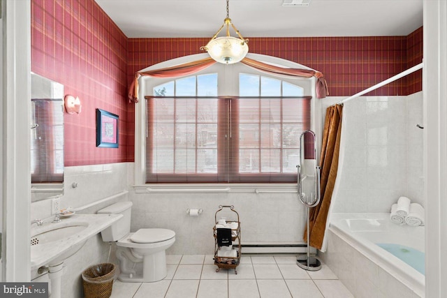 full bathroom featuring shower / bath combination with curtain, a baseboard heating unit, sink, tile patterned flooring, and toilet