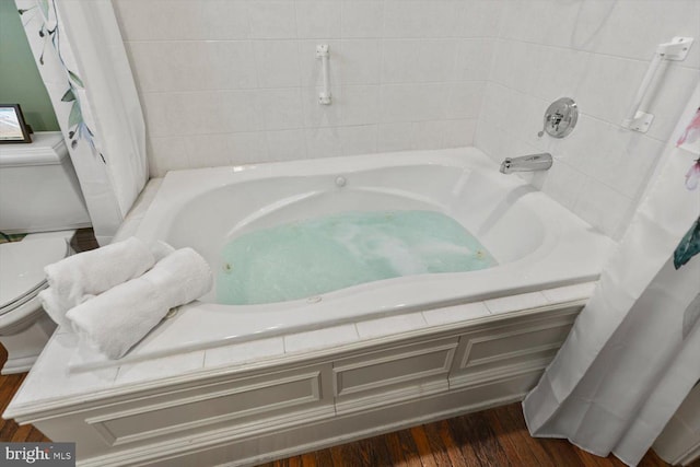 bathroom with hardwood / wood-style floors and toilet