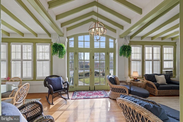 sunroom / solarium with french doors, vaulted ceiling with beams, and a notable chandelier