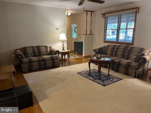 living room featuring ceiling fan and hardwood / wood-style flooring