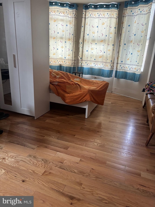 bedroom with hardwood / wood-style flooring