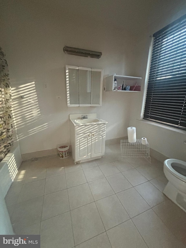 bathroom featuring tile patterned floors, vanity, and toilet