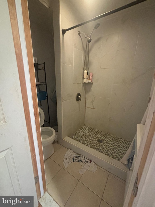 bathroom featuring a shower with curtain, tile patterned floors, and toilet