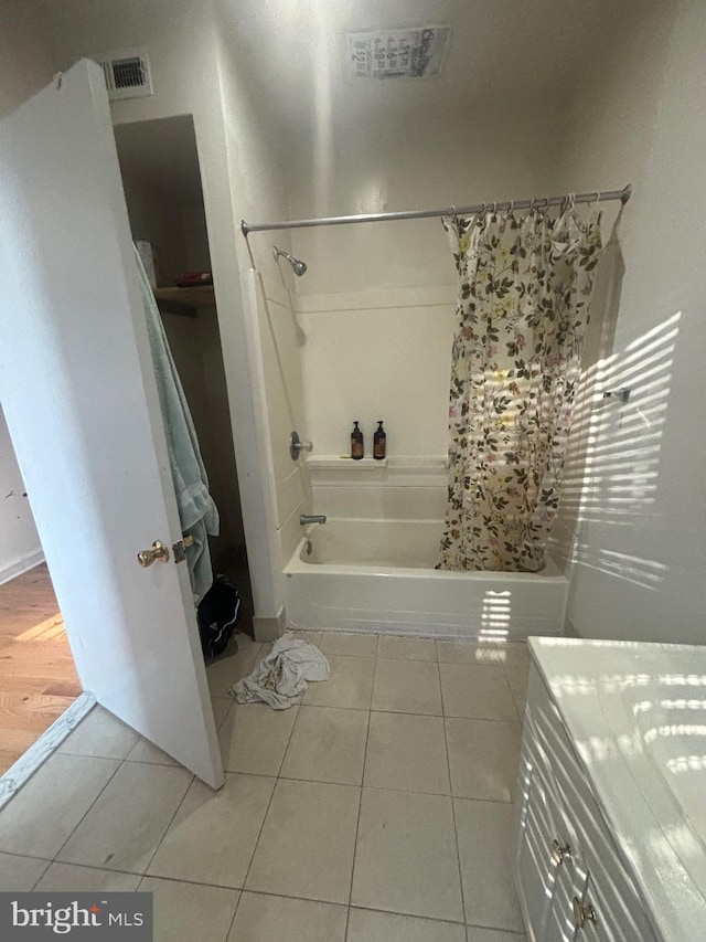 bathroom featuring vanity, tile patterned floors, and shower / tub combo with curtain