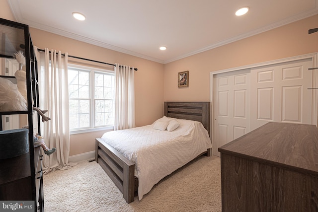 bedroom with a closet, light colored carpet, and ornamental molding