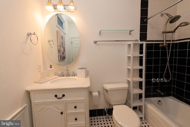 full bathroom featuring vanity, toilet, and tiled shower / bath