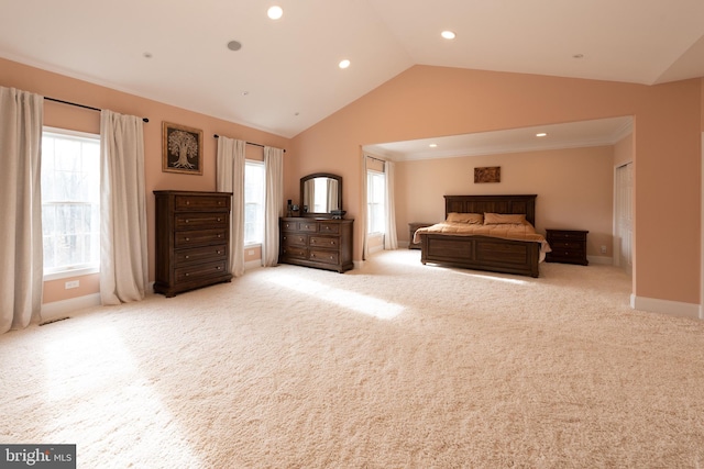 bedroom featuring light carpet, vaulted ceiling, and ornamental molding