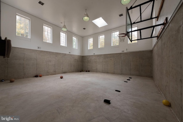 interior space featuring concrete flooring and a skylight