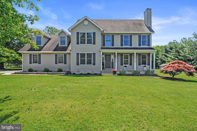 colonial-style house featuring a front lawn