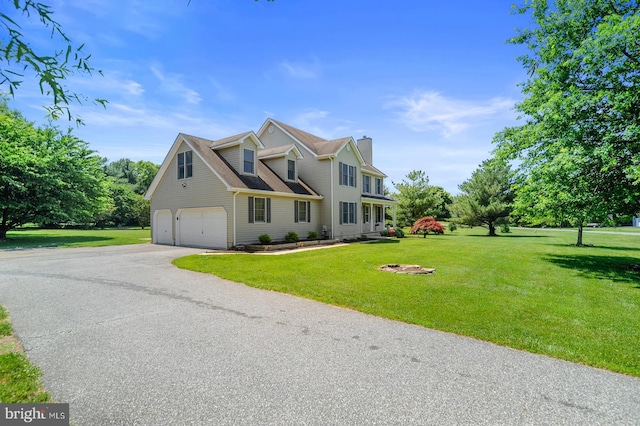 view of front of property with a front yard and a garage