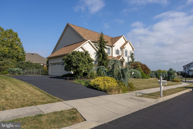 view of front of home with a garage and a front yard