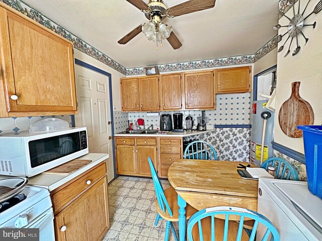 kitchen with ceiling fan, sink, and white appliances