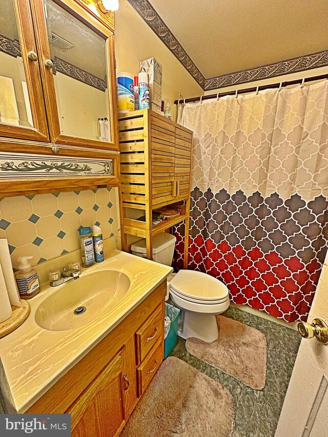 bathroom with backsplash, vanity, toilet, and a shower with curtain