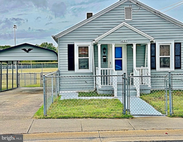 bungalow-style home featuring a carport and a porch