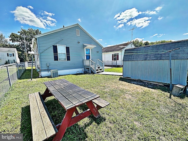 view of yard featuring a storage unit and central air condition unit