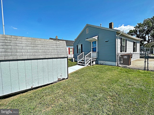 rear view of house featuring a lawn