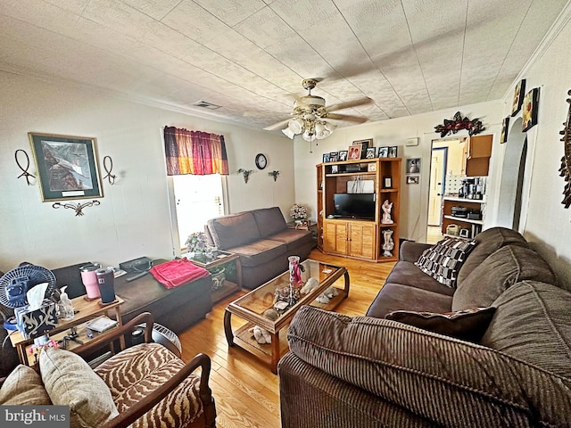 living room with light hardwood / wood-style floors and ceiling fan