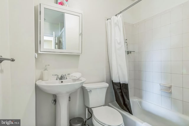 bathroom with shower / bath combo and toilet