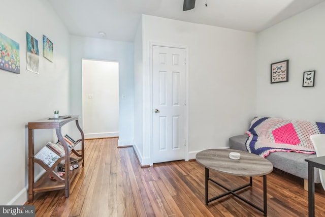 sitting room featuring hardwood / wood-style floors and ceiling fan