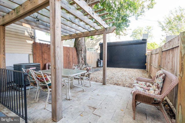 view of patio / terrace with central AC unit and a pergola