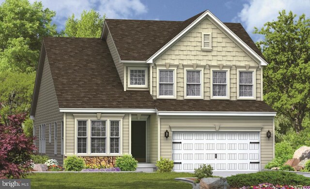 view of front of property featuring a garage and a front lawn