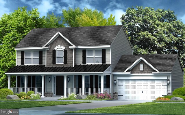 view of front of house with a front yard, a garage, and covered porch