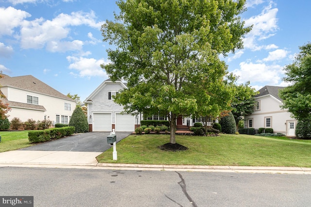 obstructed view of property with a front yard and a garage