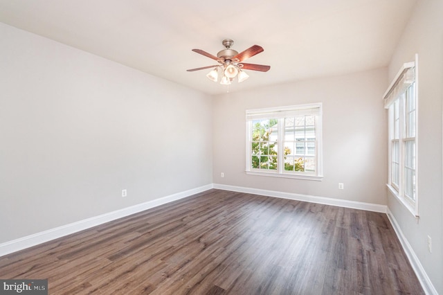 unfurnished room with ceiling fan and dark wood-type flooring