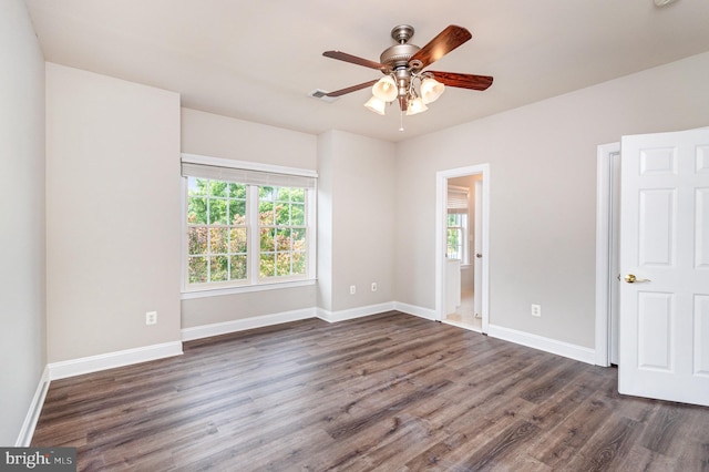 spare room with ceiling fan and dark hardwood / wood-style floors