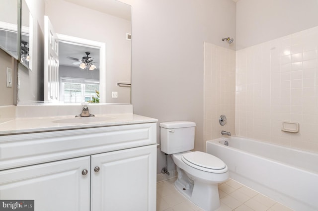 full bathroom featuring vanity, tiled shower / bath combo, toilet, and tile patterned floors