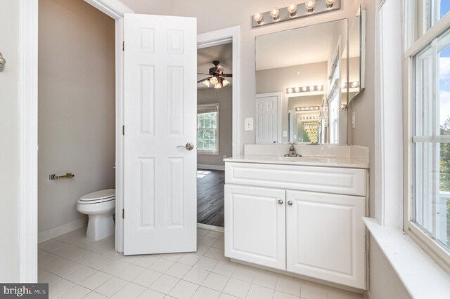 bathroom featuring vanity, toilet, ceiling fan, and tile patterned floors